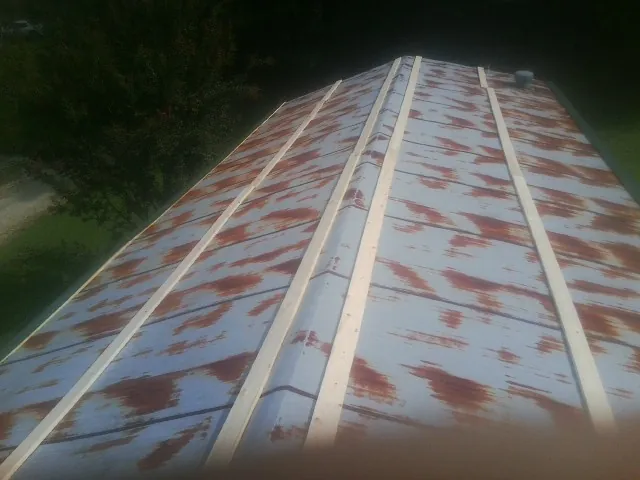 Rusted metal roof panels with new wood purlins before replacement — Storm Damage Roof Repair in Orangeburg by Roofing Brothers