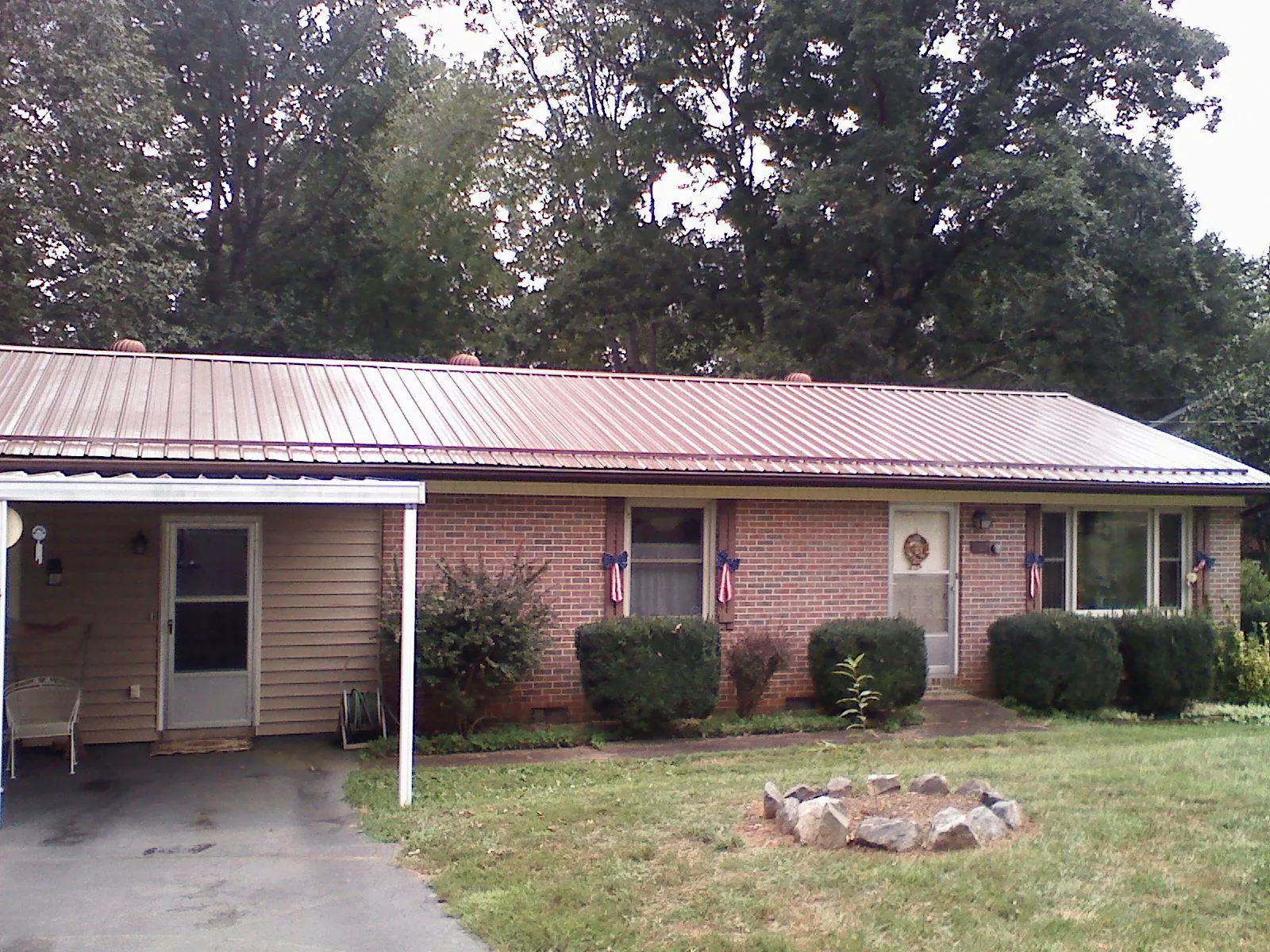 Bronze metal roof and carport on a brick ranch home — Roof Repair work by our crew in Orangeburg