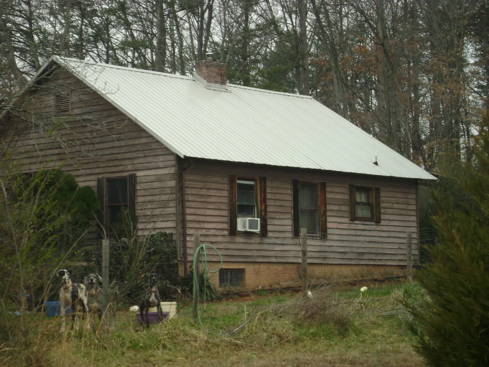 White metal roof on an old wood sided farmhouse, from a Metal Roof Installation job in Orangeburg